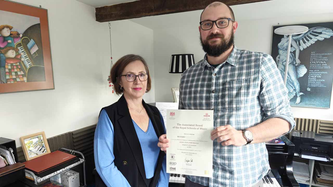 Anna Peszko presenting an ABRSM Grade 5 Piano Performance certificate to her pupil Richard