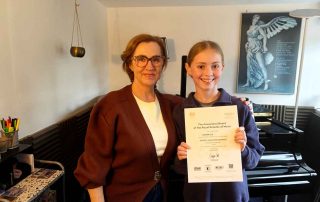 Anna presenting Gabrielle with her Grade 2 distinction certificate