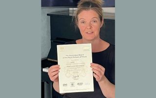 Emma with her ABESM Grade 2 Distinction certificate