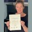 Emma with her ABESM Grade 2 Distinction certificate