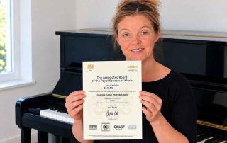 Emma celebrating her ABRSM Piano Performance Grade 3 Distinction