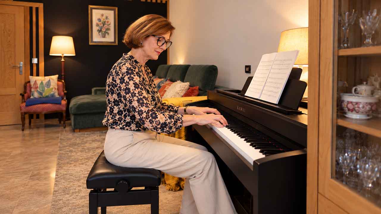 Anna Peszko playing her Kawai digital piano at home in Ronda, Spain, illustrating the ABRSM Initial Grade 2027–2028 piano syllabus.