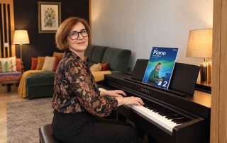 Anna Peszko at a Kawai digital piano with the ABRSM Grade 2 Piano Exam Pieces 2027–2028 book.