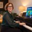 Anna Peszko at a Kawai digital piano with the ABRSM Grade 4 Piano Exam Pieces 2027–2028 book.